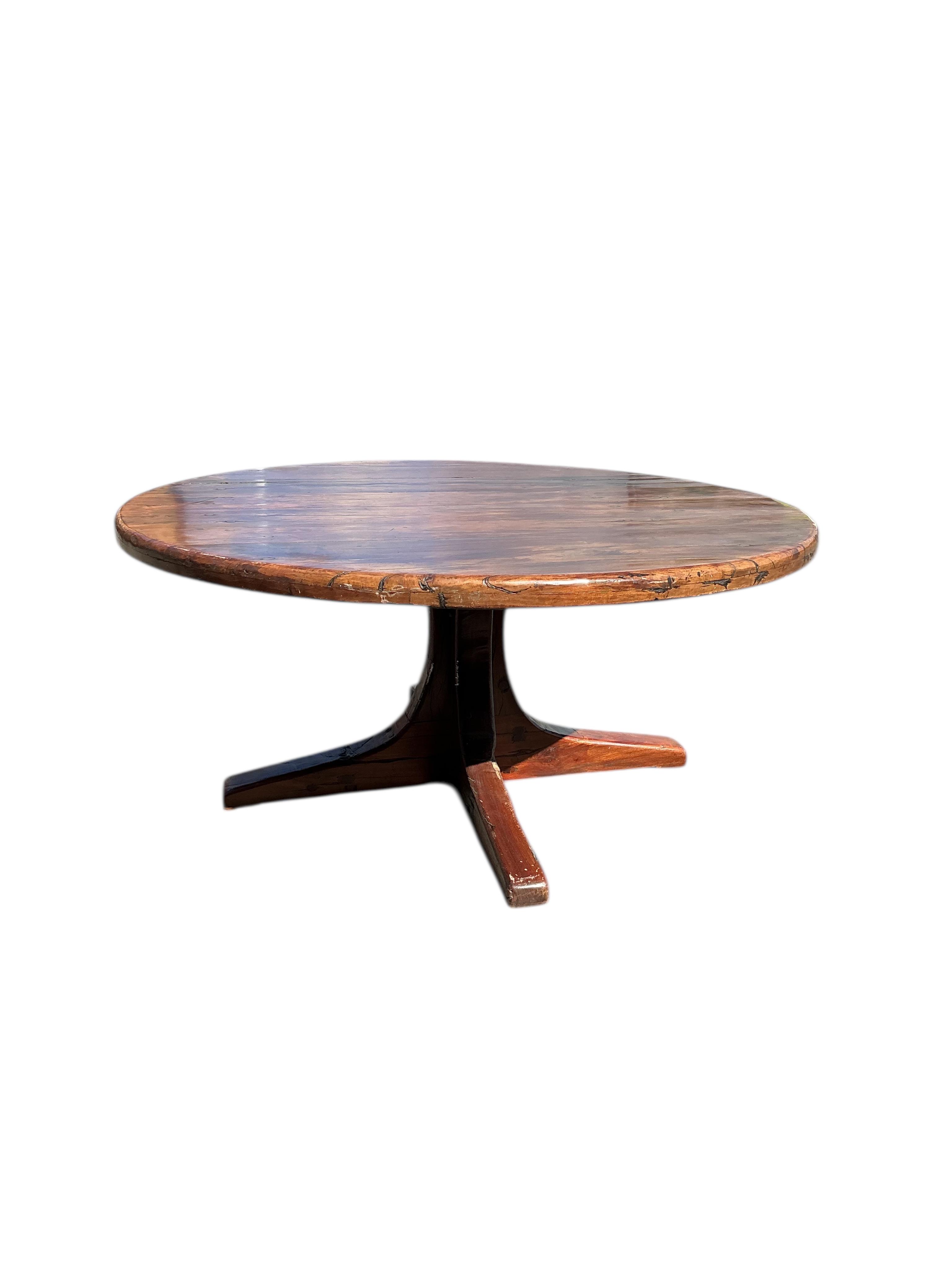 A Zimbabwean reclaimed Jarrah railway sleeper hardwood circular pedestal dining table, diameter 170cm, height 75cm and eight chairs by Rail Antiques, Harare, each piece stamped Rail Antiques